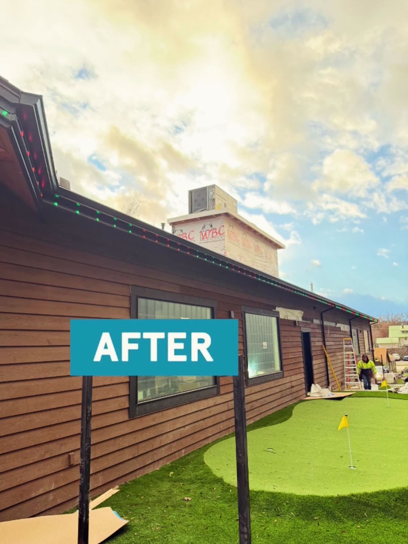 Exterior renovation of a building with landscaping and signage labeled "AFTER".