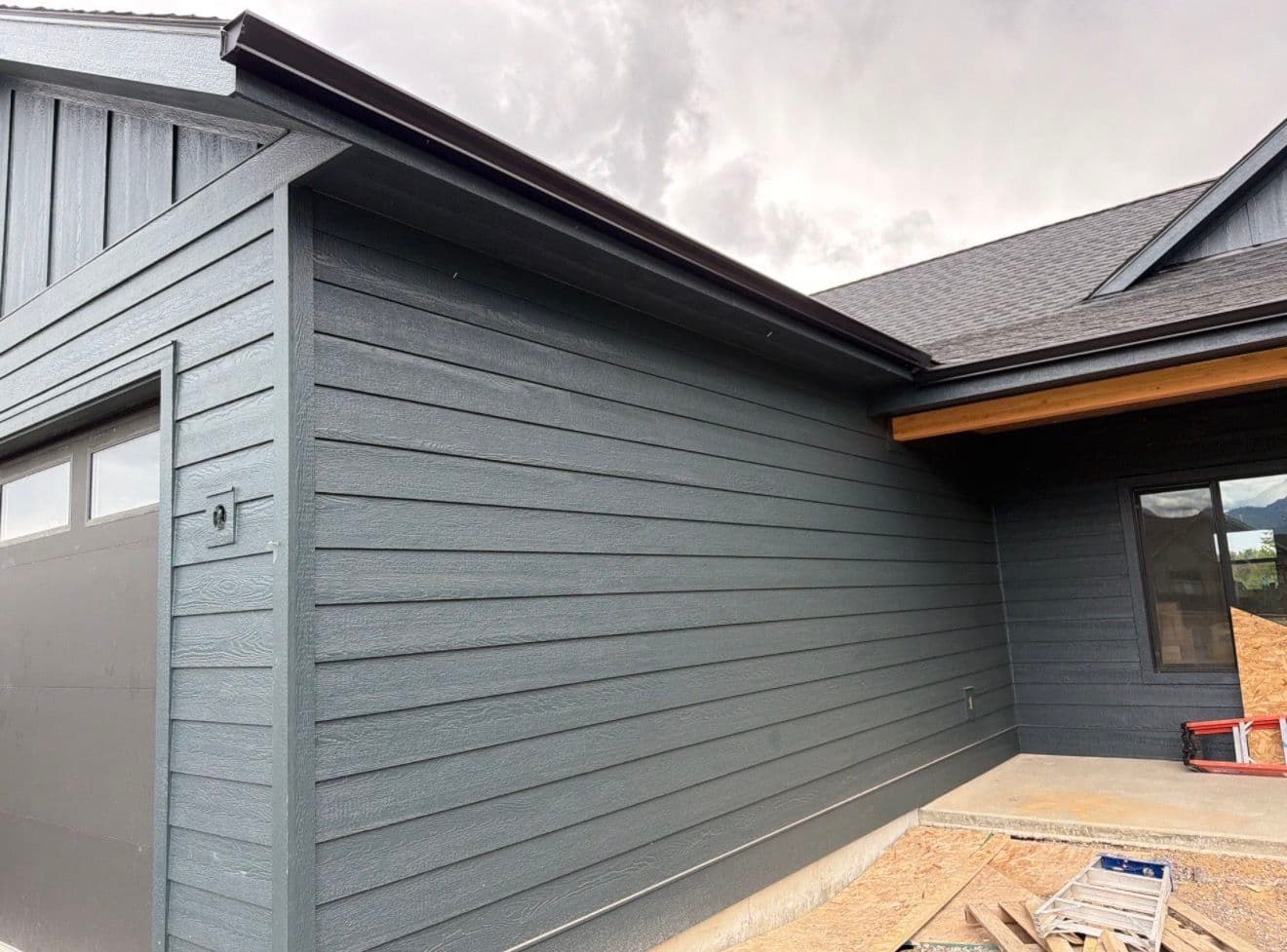 Black Gutter Installation with Oversized Downspouts on New Construction image