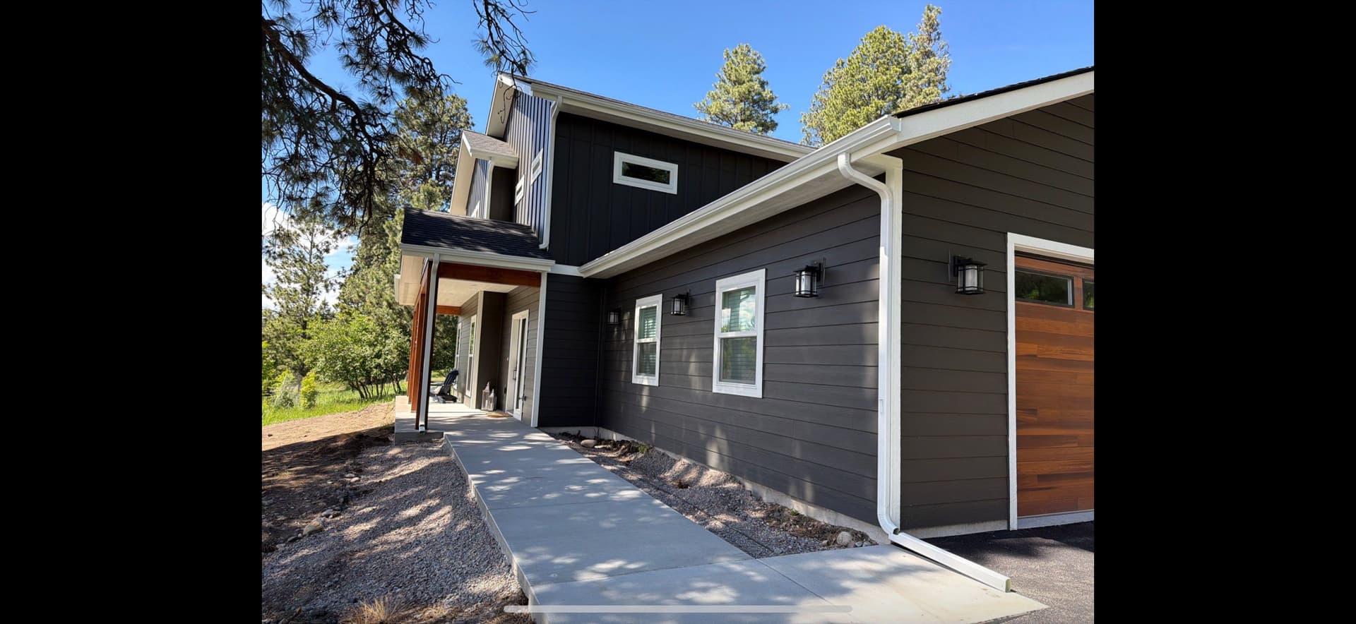 Seamless White Gutter Installation on a Two-Story Modern Home image
